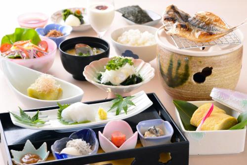 a table filled with different types of sushi dishes at Ito Yukitei in Ito