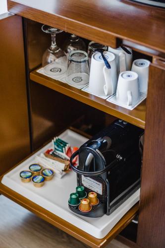 a coffee maker on a shelf in a cabinet at Napa Plaza Hotel (Adults Only) in Ayia Napa