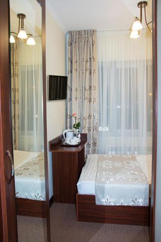a bedroom with two beds and a mirror at Silk Way in Almaty