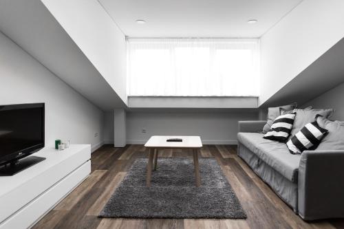 a living room with a couch and a table at Deluxe Apartments by Hostlovers in Kaunas