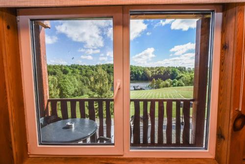 a window with a view of a table on a balcony at Svajonių Dvaras in Balninkai