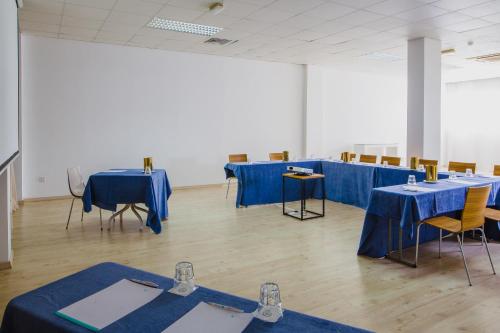 a room with tables and chairs with blue table cloths at Napa Plaza Hotel (Adults Only) in Ayia Napa