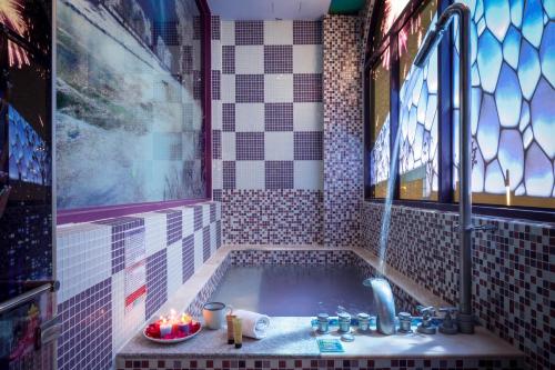a bathroom with a bath tub with a sink at Chihpan City in Wenquan