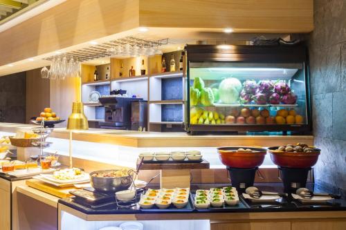 a kitchen with fruits and vegetables on a counter at Pacific Business Hotel in Taipei