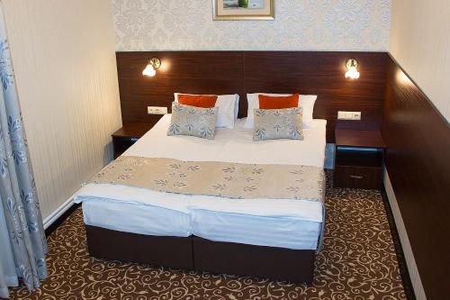 a bedroom with a large bed in a hotel room at Silk Way in Almaty