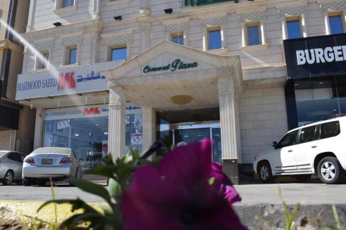 a purple flower in front of a building at Concord Plaza in Hafr Al Baten