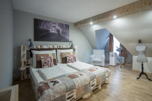 a bedroom with a large bed in a room at Hotel Carpe Diem in Siófok