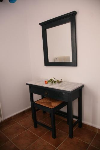 a black table with a mirror on a wall at Villa Carina in Kounopetra