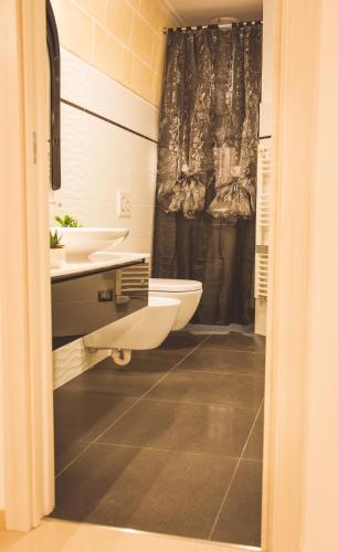 a bathroom with a sink and a toilet and a shower at Daddy's house in Matera