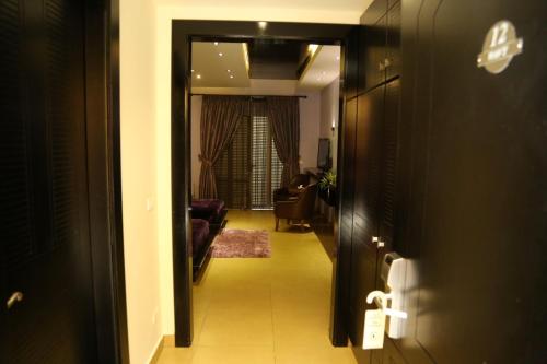 a hallway leading to a room with a living room at Layali Al Shams Hotel in ‘Anjar