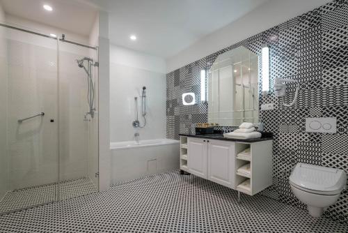 a bathroom with a shower and a toilet and a sink at Royal Palace in Turčianske Teplice