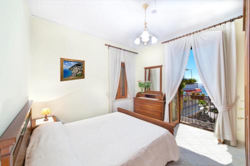 a bedroom with a bed and a balcony at Villa Costanzo beach front in Positano