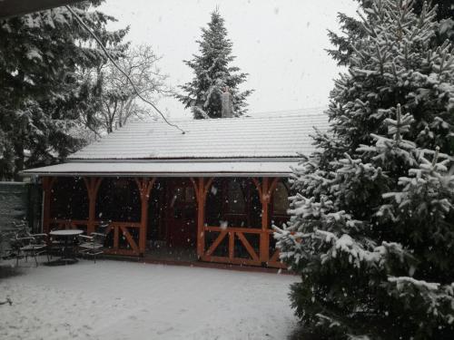 a wooden gazebo with snow on it at Prenoćište Vila Stara Breza in Palić