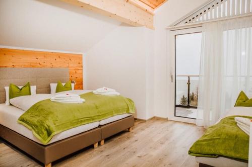a bedroom with a large bed and a window at Appartements Almnest in Schladming