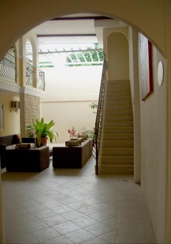 a lobby with a staircase and a stair case at The Suites at Calle Nueva in Bacolod
