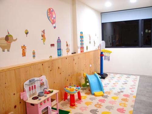 a childs room with a play area with toys at 23 Here B&B in Hualien City