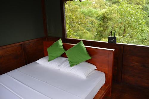 A bed or beds in a room at Dambulla Tree House