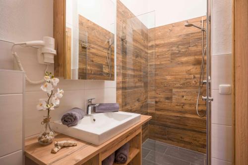 a bathroom with a sink and a shower at Residenz Gamper in Brixen im Thale