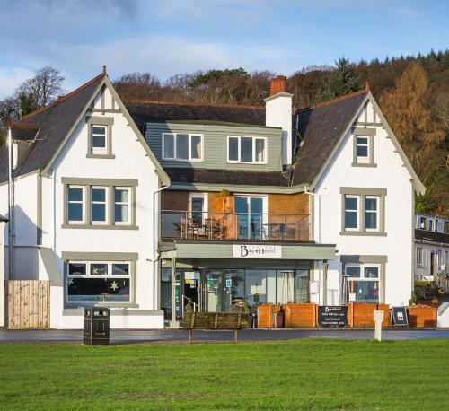 uma grande casa branca com uma frente de loja em Lamlash Bay Hotel em Lamlash