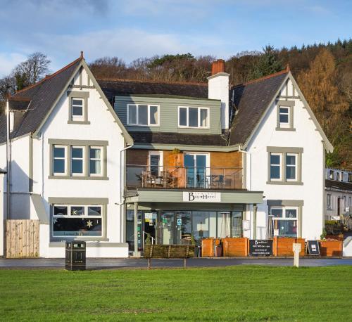 a large white house with a store front at Lamlash Bay Hotel in Lamlash