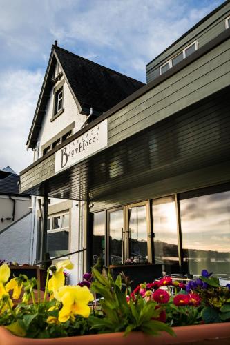 a building with a bunch of flowers in front of it at Lamlash Bay Hotel in Lamlash