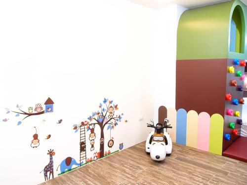 a childs room with a toy car on the floor at 23 Here B&B in Hualien City