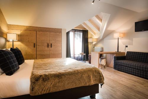 Кровать или кровати в номере Hotel Alù Mountain Design