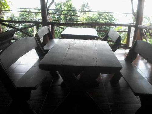 a wooden table and chairs on a porch at Bang Son Golden View in Baan Khai