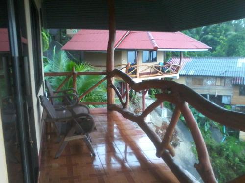 a balcony with a view of a house at Bang Son Golden View in Baan Khai