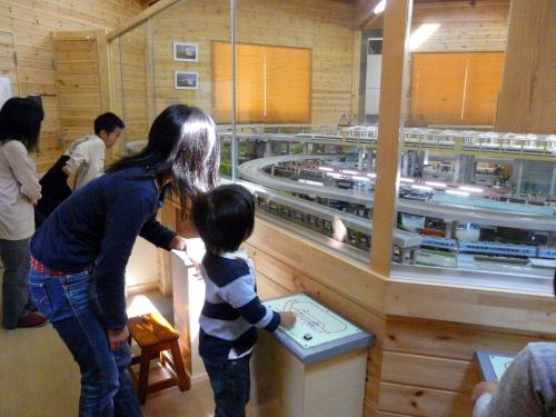 a woman and a child looking at a train display at Log Cottage Epoch in Hakuba