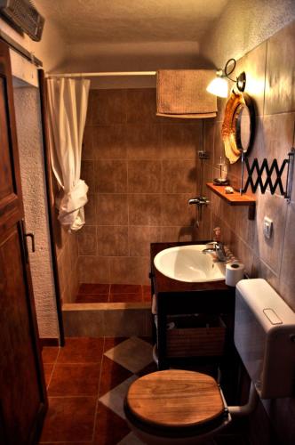 a bathroom with a sink and a toilet and a shower at Tvrdic Honey in Grohote