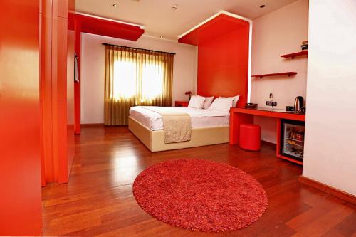 a bedroom with a bed and a red rug at Eternity Boutique Hotel in Istanbul