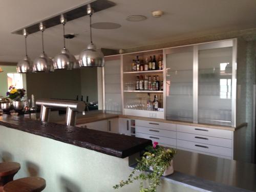 a kitchen with white cabinets and a counter top at Akzent Berghotel Rosstrappe in Thale