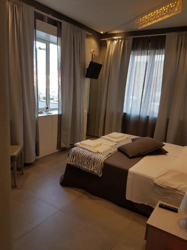 a bedroom with a bed and a large window at Maliziusella in Naples
