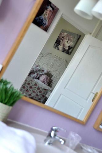 a mirror above a sink in a bathroom at Château De Matel in Roanne