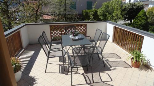 a patio with a table and chairs on a balcony at Il Granello in Tuenno