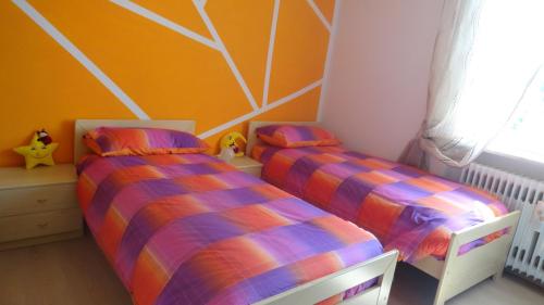 a bedroom with two beds and a ceiling at Il Granello in Tuenno