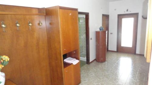 a room with a large wooden cabinet in a building at Il Granello in Tuenno