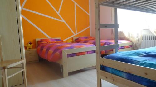 a bedroom with two bunk beds and a wall at Il Granello in Tuenno