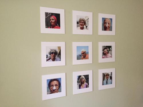 a wall with pictures of older people on it at Das Hotel Ostseeblick in Lütjenburg
