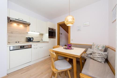 a kitchen and dining room with a table and chairs at Haus Fercher in Grossarl