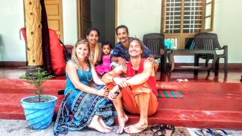 a group of people sitting on the steps of a house at Marari Nadiya in Mararikulam