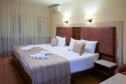 a hotel room with a large bed with towels on it at 7 Sky Hotel Klinicheskaya Street (2d entrance) in Kyiv