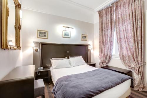 a bedroom with a large bed and a large window at Hotel Opera Maintenon in Paris