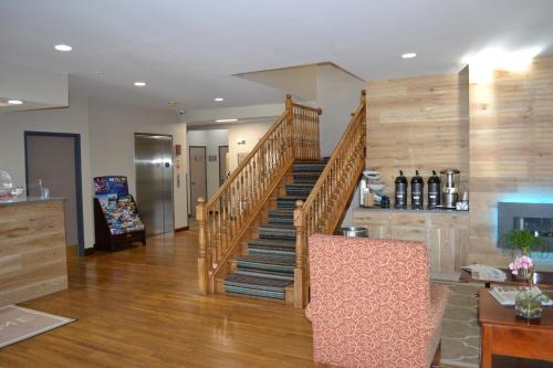 a wooden staircase in a living room with wooden floors at Country Inn & Suites by Radisson, Gurnee, IL in Gurnee