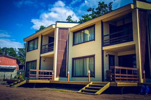 a house with two decks on the side of it at Okunevaya Holiday Park in Ozerki