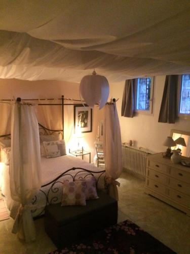 a bedroom with a canopy bed and a dresser at Reiser in Épernay