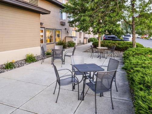 a group of tables and chairs on a sidewalk at Kelly Inn Billings in Billings