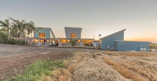 a house on a hill with a field at Gold 68- גולד 68 סוויטות בוטיק in Kefar Barukh