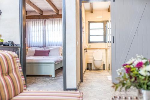 a room with a bed and a mirror at Gold 68- גולד 68 סוויטות בוטיק in Kefar Barukh